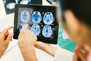 Doctor and patient using digital tablet in hospital